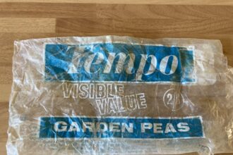 Volunteers at Greenaleigh Sand Beach, Somerset, found a 53-year-old plastic peas bag with a shilling price tag, highlighting plastic's longevity and sparking local amazement.