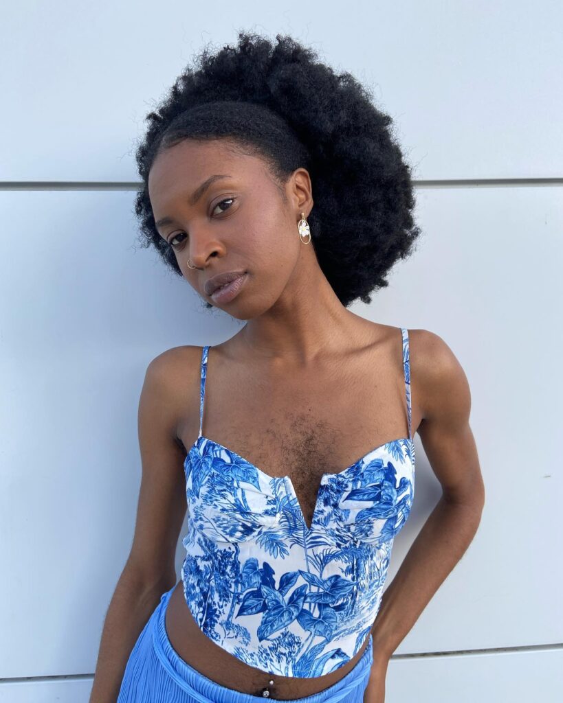 Esther Calixte-Bea, 28, proudly embraces her body hair, challenging social norms and feeling confident and beautiful in the summer without shaving.