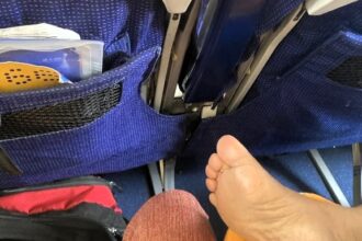 A plane passenger sparked debate by sharing a photo of a bare foot next to her leg on a flight from Bagdogra to Mumbai, India. Reactions were mixed on Reddit.