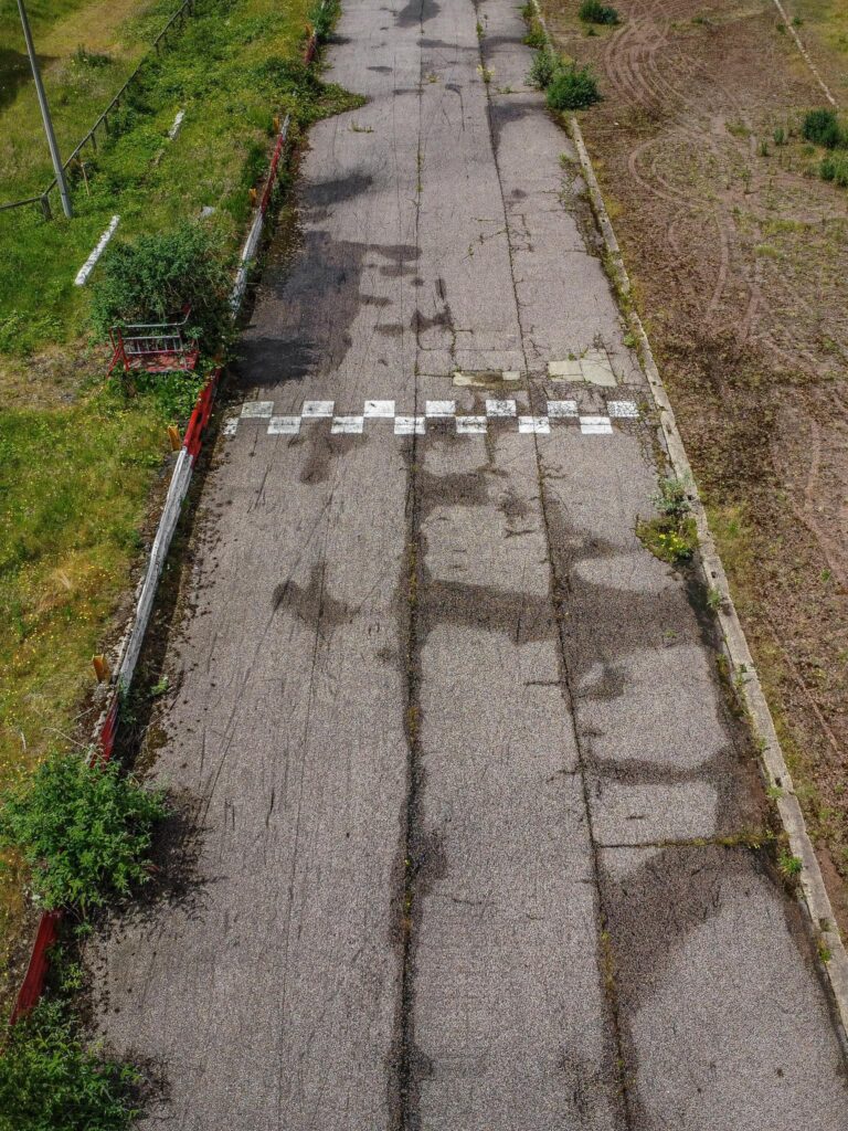 An explorer discovered the abandoned Arena Essex racetrack, now reclaimed by nature. Once a bustling site, it closed in 2018. Fans recall fond memories of the track.