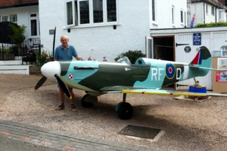 Retired handyman Rikki Scott, 76, builds stunning three-quarter scale Spitfire replica in his Torquay garage over three years, amazing neighbors with his craftsmanship and dedication.