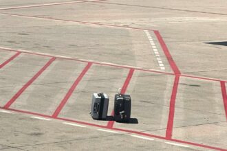 A passenger at Madrid's Barajas airport spotted his family's suitcases left on the tarmac before takeoff. Despite the mishap, their luggage, including cheese, arrived safely later.