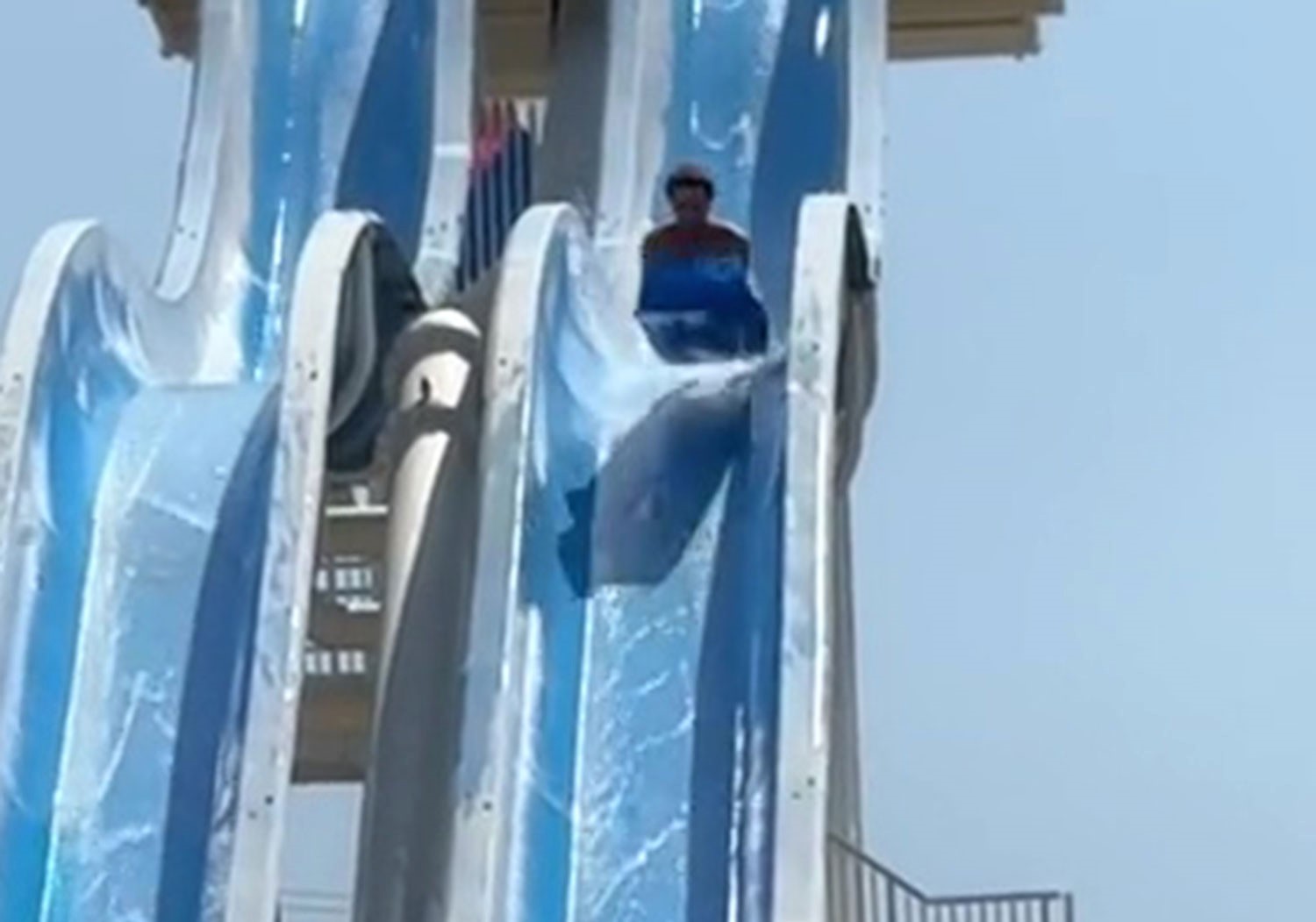 Terrifying moment caught on video as man nearly falls off a steep waterslide in South France. The TikTok clip, shared by his twin, has gone viral with over 4.1 million views.