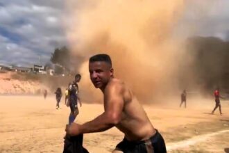 A dust devil halted an amateur football match in Ribeirão das Neves, Brazil. The whirlwind, caught on video, caused a brief pause but no injuries. Watch the dramatic clip.