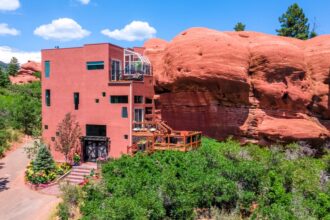 A unique Colorado home built into ancient red rocks, seamlessly blending modern living with nature. Explore this 4-level gem, listed just under $1 million.