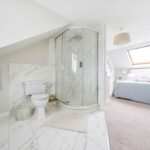 A £550,000 Saffron Walden home with a controversial open-plan en-suite raises hygiene concerns but offers four bedrooms, a large garden, and spacious living areas.