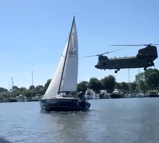 A casual speedboat ride turns thrilling as a man races a low-flying Chinook helicopter, capturing the GTA-like moment with over 220,000 views on social media.