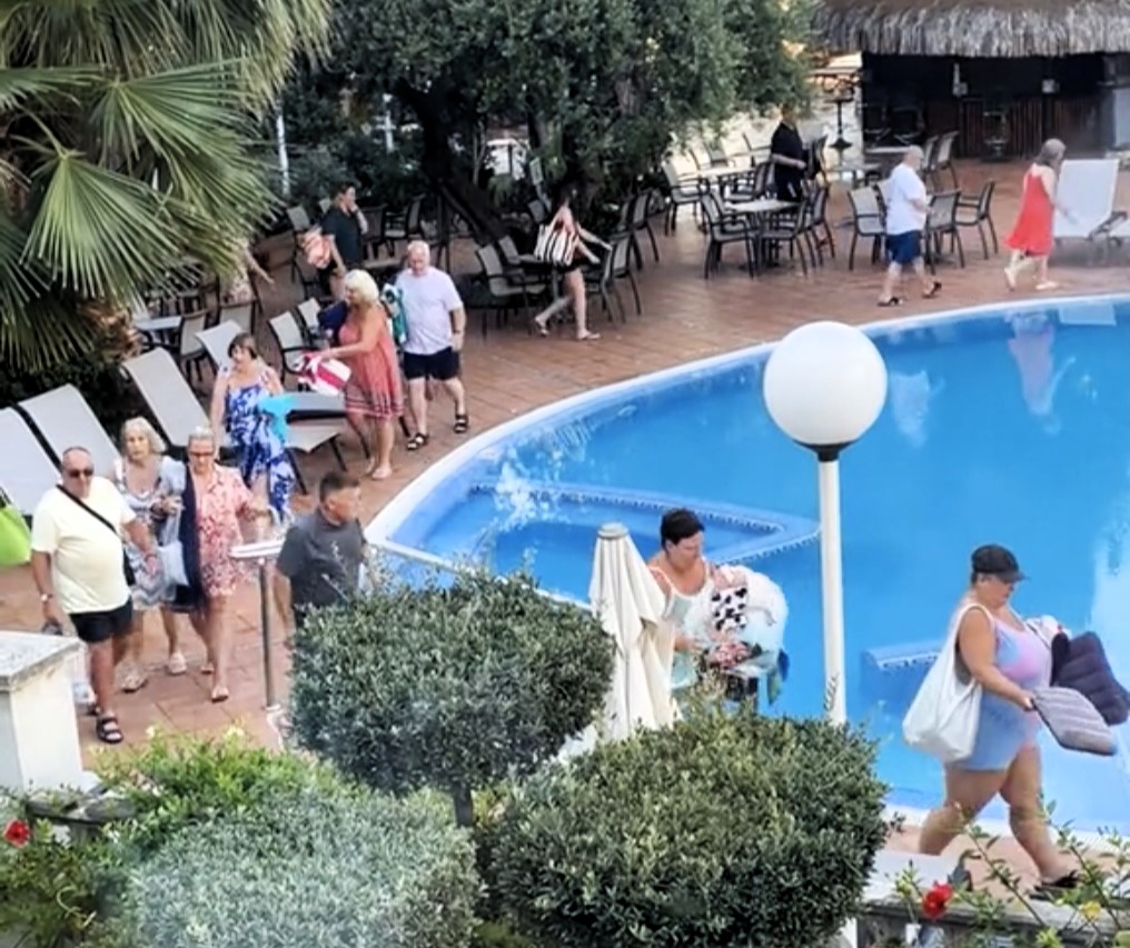 British holidaymakers race to secure sun loungers at H10 Delfin in Salou, Spain, despite the hotel's no-reserve rule, turning the early morning dash into a daily spectacle.