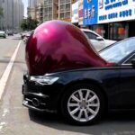 Bizarre viral footage shows cars developing ‘baby bumps’ in China during an extreme heatwave, sparking social media frenzy with jokes and theories on the unusual phenomenon.