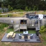 Stay in a former Royal Navy helicopter at RAF Wainfleet in Lincolnshire. Experience unique military-themed accommodations with stunning lakeside views starting at £130/night.