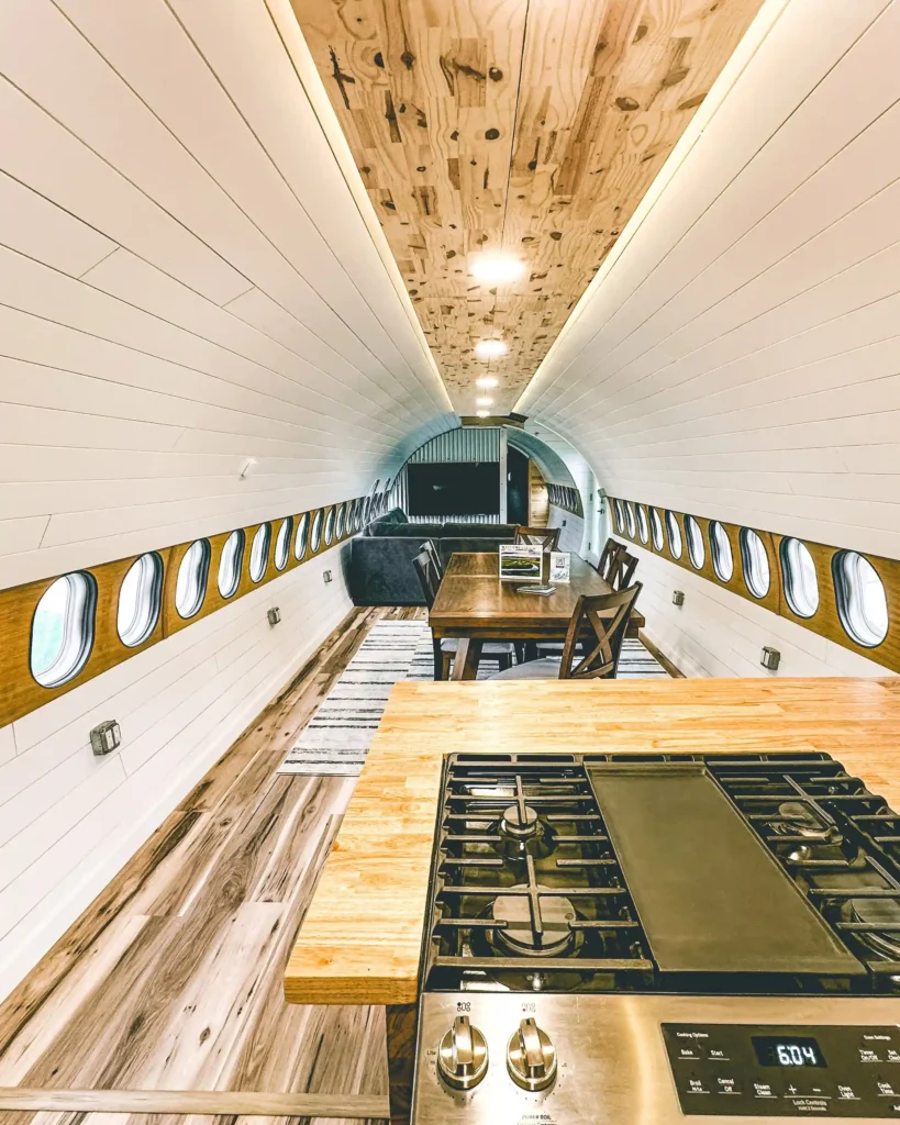 Experience a unique stay in a converted DHL jet turned Airbnb, complete with a wing deck and sauna, nestled in the breathtaking Alaskan wilderness. Book now for an unforgettable adventure!