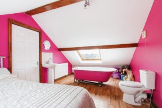 Quirky £360K Leeds home hits the market with a toilet just inches from the bed in a pink-themed bedroom, plus four more bedrooms, open-plan kitchen, and a garden.