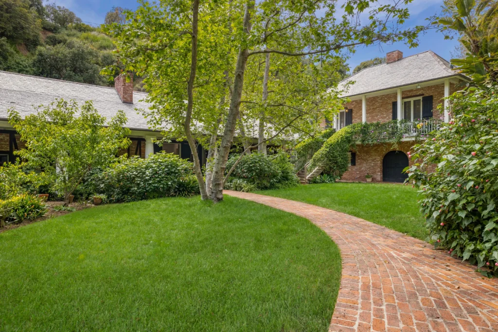 The luxurious $14M estate once owned by Michelle Pfeiffer, nestled in LA's Pacific Palisades, featuring a stunning pool, lush gardens, and celebrity neighbors.