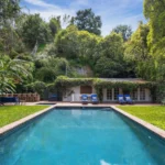 The luxurious $14M estate once owned by Michelle Pfeiffer, nestled in LA's Pacific Palisades, featuring a stunning pool, lush gardens, and celebrity neighbors.