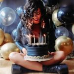 Birthday girl's hair catches fire while blowing out candles during a photoshoot. Despite the scare, she remains calm, and the flames are quickly extinguished. Video goes viral.