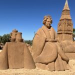 A sand sculpture of Queen Elizabeth II in Portugal remains unchanged nearly two years after her death, with errors on the plaque sparking criticism from tourists.