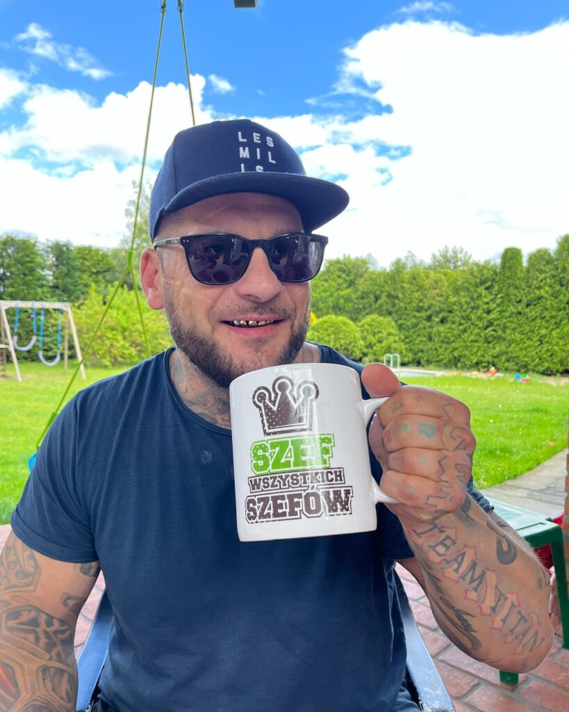 Polish rapper Popek, known for his extensive face tattoos, undergoes painful removal procedures, expressing regret over past decisions influenced by alcohol and ex-relationships.