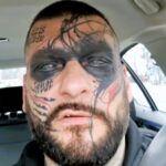 Polish rapper Popek, known for his extensive face tattoos, undergoes painful removal procedures, expressing regret over past decisions influenced by alcohol and ex-relationships.