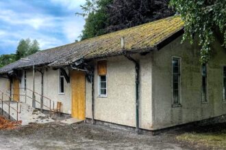 Urban explorer discovers eerie abandoned mortuary with rotting coffins, fridge lockers, and a cobweb-filled chapel. Her chilling find goes viral on TikTok, captivating viewers.