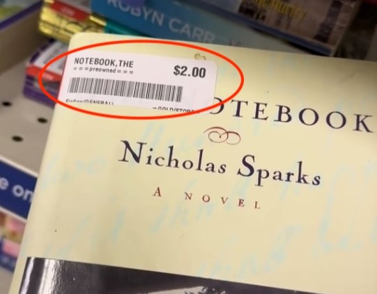 A woman finds a signed first edition of Nicholas Sparks' "The Notebook" for just $2 at a charity shop, potentially worth £300, sparking excitement and disbelief online.