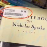 A woman finds a signed first edition of Nicholas Sparks' "The Notebook" for just $2 at a charity shop, potentially worth £300, sparking excitement and disbelief online.