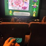 A woman and her friends rented an entire cinema screen to play Mario Party, going viral for their nostalgic gaming session. The $100 experience has inspired many online.