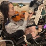 A violinist with Ehlers-Danlos syndrome shares her journey from paralysis to skull surgery, raising awareness about the condition and advocating for early diagnosis and treatment.