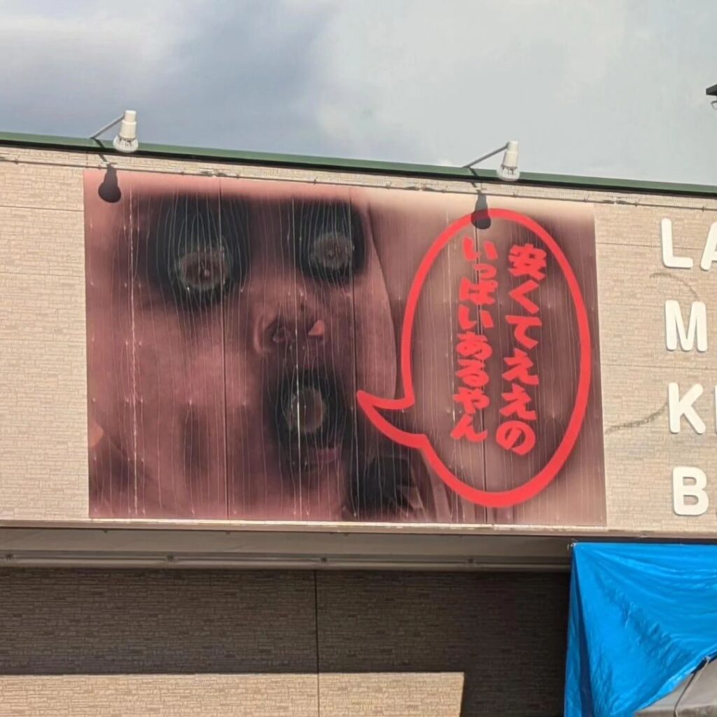 A store billboard's baby face melted by heatwave now resembles a horror image, sparking attention and jokes as Halloween approaches, with visitors flocking for photos.