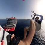 Kitesurfer Tom Bridge stunned holidaymakers by leaping 129ft from a cruise ship in Greece. The daring stunt, a year in the making, was a thrilling success.