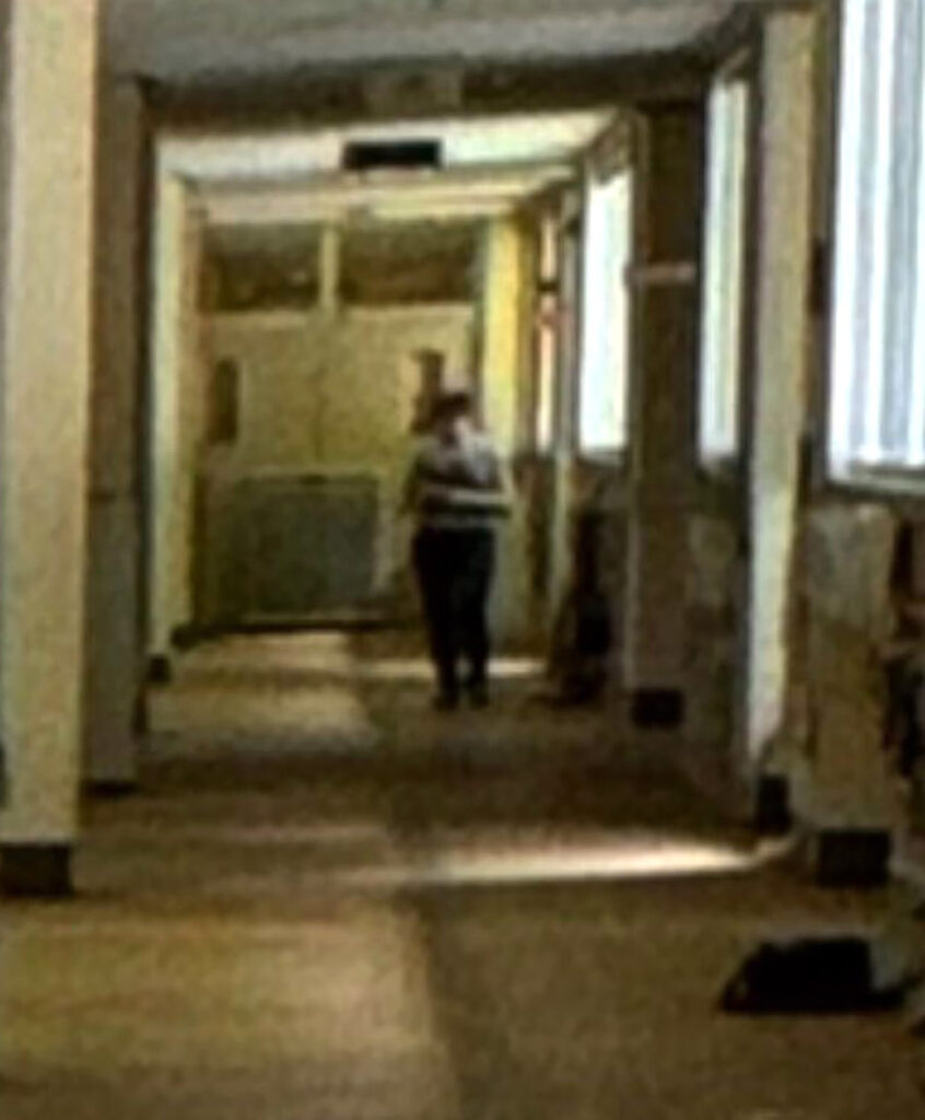 Urban explorer discovers eerie abandoned school frozen in time, with homework still pinned and a ghostly figure lurking in the hallway, sending chills down his spine."