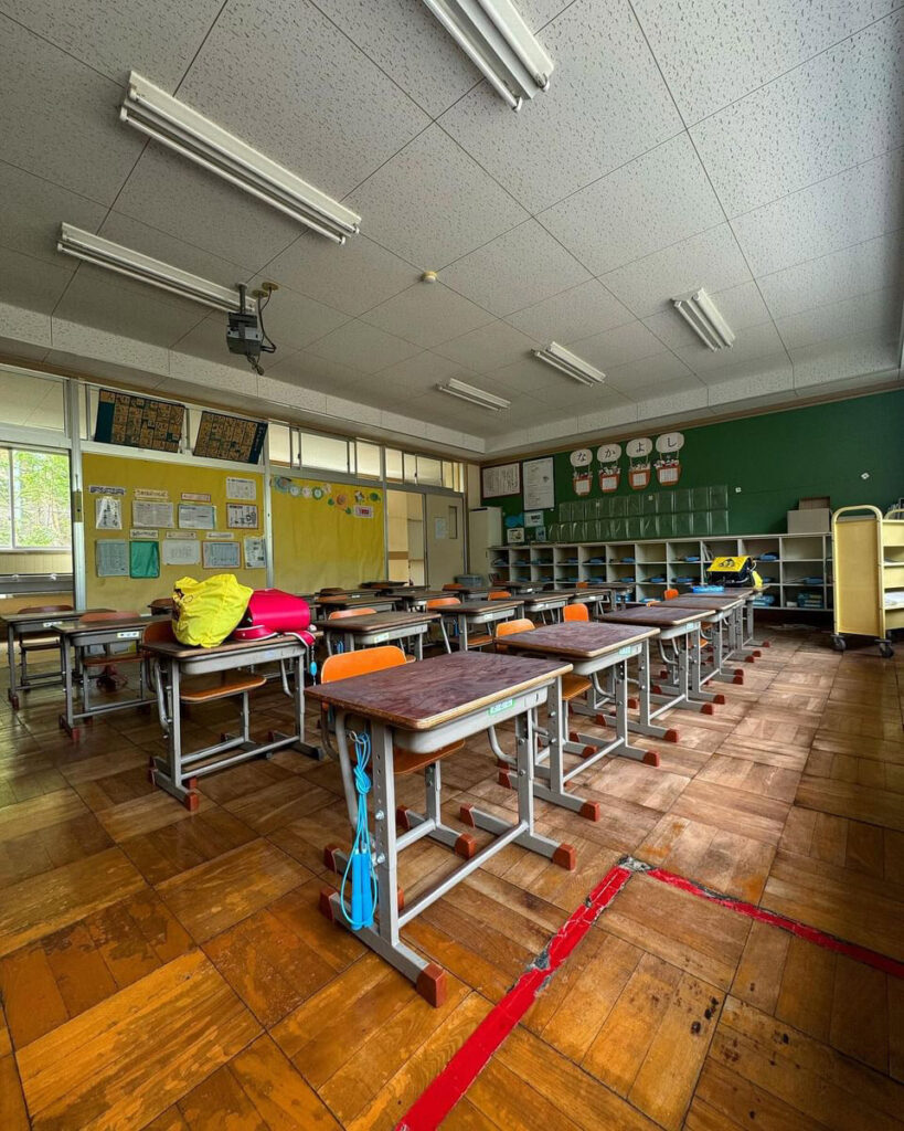 Urban explorer discovers eerie abandoned school frozen in time, with homework still pinned and a ghostly figure lurking in the hallway, sending chills down his spine."