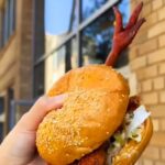 A New York restaurant's fried chicken sandwich, complete with a chicken foot poking out, has sparked debate, with some praising its freshness and others calling it off-putting.