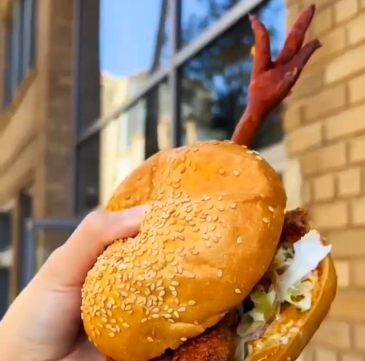 A New York restaurant's fried chicken sandwich, complete with a chicken foot poking out, has sparked debate, with some praising its freshness and others calling it off-putting.