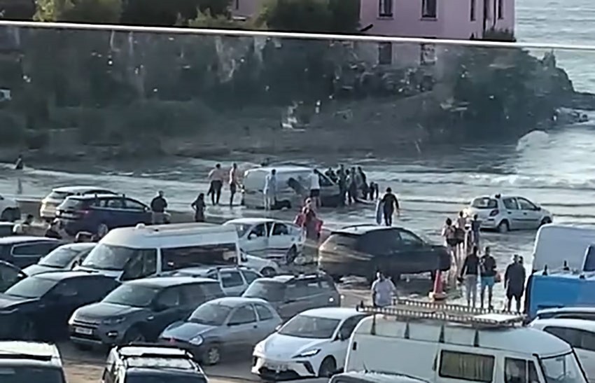 A tourist van got stuck on Polzeath beach in Cornwall as high tide approached, continuing the trend of “idiot season” incidents, with locals rushing to help free the vehicle.