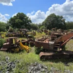 Explorer Daniel Sims uncovers an abandoned field filled with diggers and tractors worth millions in scrap metal and parts, sharing the incredible find with his YouTube followers.