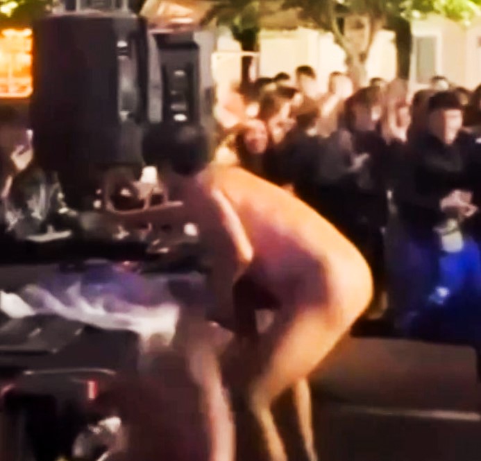 DJ Rigo Pex, aka "Meneo," shocked festivalgoers in Sonseca, Spain, by stripping naked during his set, prompting security to intervene and sparking controversy over the bizarre incident.