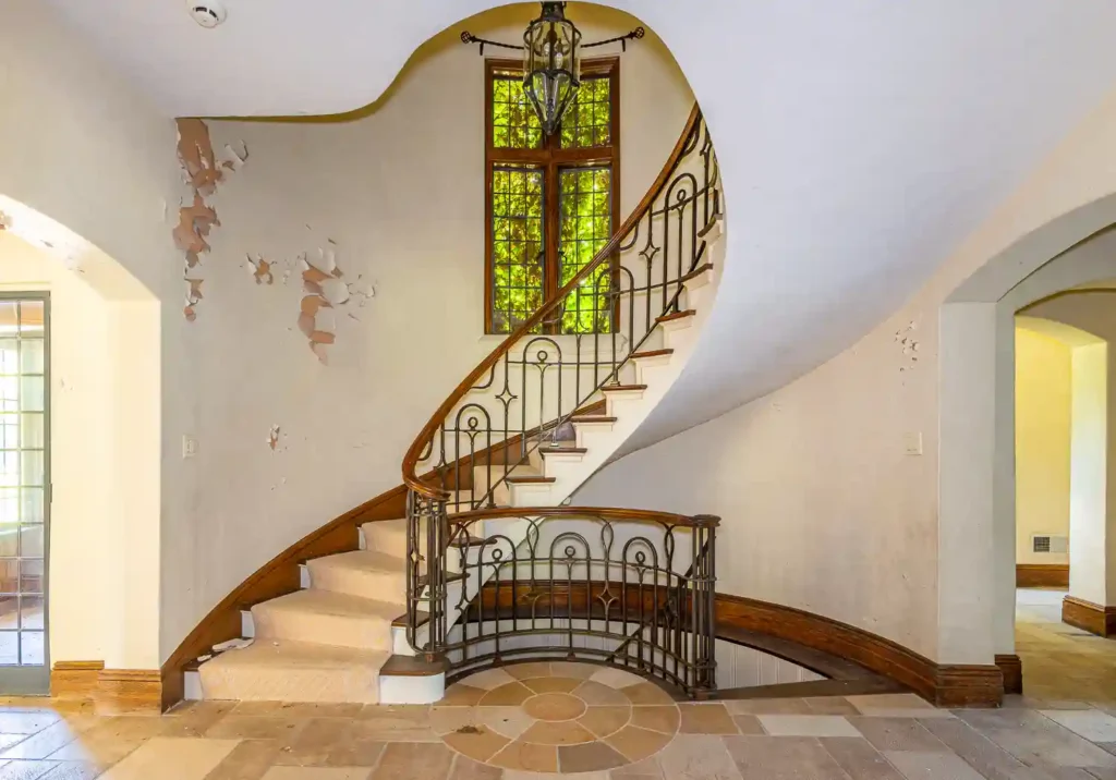 Urban explorer discovers abandoned $8.1M mansion with six bedrooms, pool, and basketball court. Once a luxurious estate, it's now set for demolition, captivating viewers.