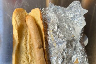 Football fans slam a £4.50 hot dog at Northampton Town’s match for its pale, bland appearance, calling it "anaemic" and joking it looks "cooked on a radiator."