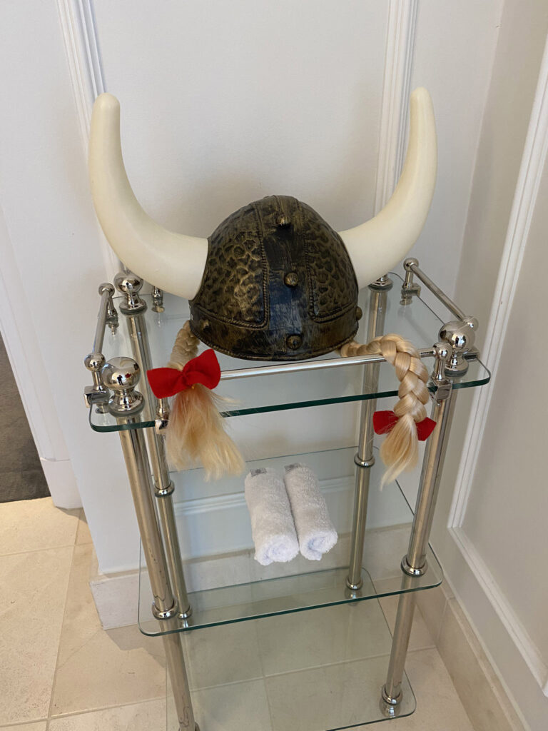 Ricky Gervais gets a cheeky surprise at his Copenhagen hotel: a Viking helmet left with a playful note. Fans urge him to recreate his iconic bath selfie with the gift.