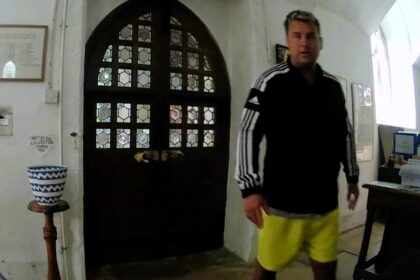 Ghosthunter Tony Ferguson was spooked when a heavy church door mysteriously opened by itself during an investigation at St John's Church, sparking claims of paranormal activity.