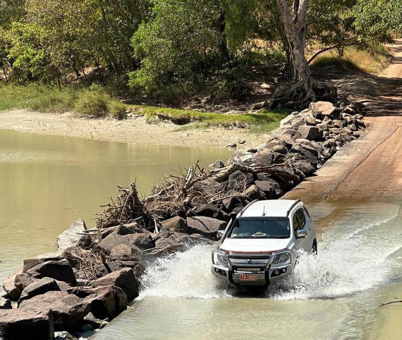 Two men were rescued from crocodile-infested waters by a heroic truck driver at Cahills Crossing, Australia, after their car got stuck in rising tides, sparking online outrage.