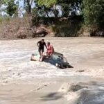 Two men were rescued from crocodile-infested waters by a heroic truck driver at Cahills Crossing, Australia, after their car got stuck in rising tides, sparking online outrage.