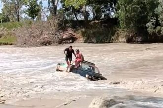 Two men were rescued from crocodile-infested waters by a heroic truck driver at Cahills Crossing, Australia, after their car got stuck in rising tides, sparking online outrage.