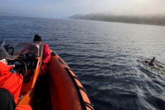 Intrepid pub landlady Dani Cameron swims the 23-mile length of Loch Ness, enduring cold and foggy conditions, while raising over £3,000 for charity—and possibly glimpsing Nessie!