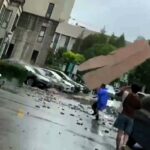 A man narrowly escaped falling debris during Typhoon Bebinca in Shanghai, as captured on video. The strongest storm in 75 years, Bebinca has left two dead and thousands evacuated.