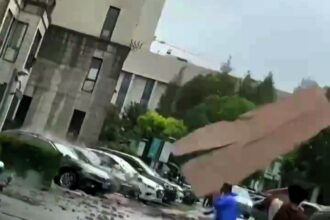 A man narrowly escaped falling debris during Typhoon Bebinca in Shanghai, as captured on video. The strongest storm in 75 years, Bebinca has left two dead and thousands evacuated.