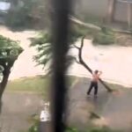 A topless man practices martial arts in the streets during Typhoon Yagi, battling extreme winds before being knocked down. The storm has caused massive damage across Asia.