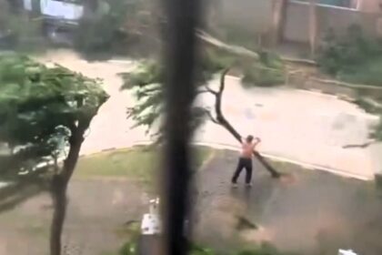 A topless man practices martial arts in the streets during Typhoon Yagi, battling extreme winds before being knocked down. The storm has caused massive damage across Asia.