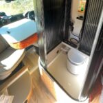 A UK couple is taking van life to the next level with their luxurious van conversions, including a motorhome featuring a hidden shower.