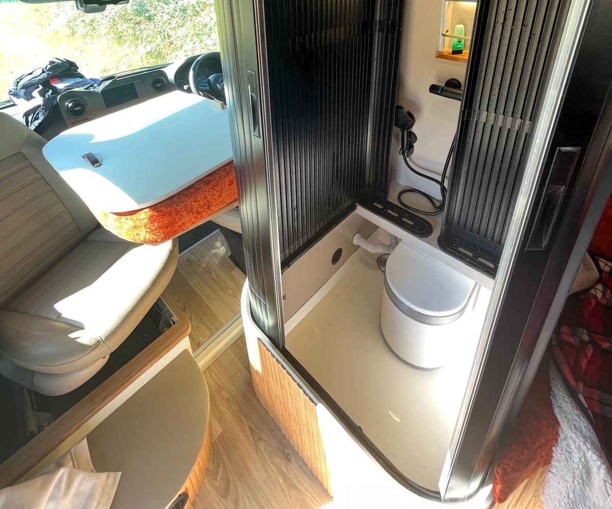 A UK couple is taking van life to the next level with their luxurious van conversions, including a motorhome featuring a hidden shower.